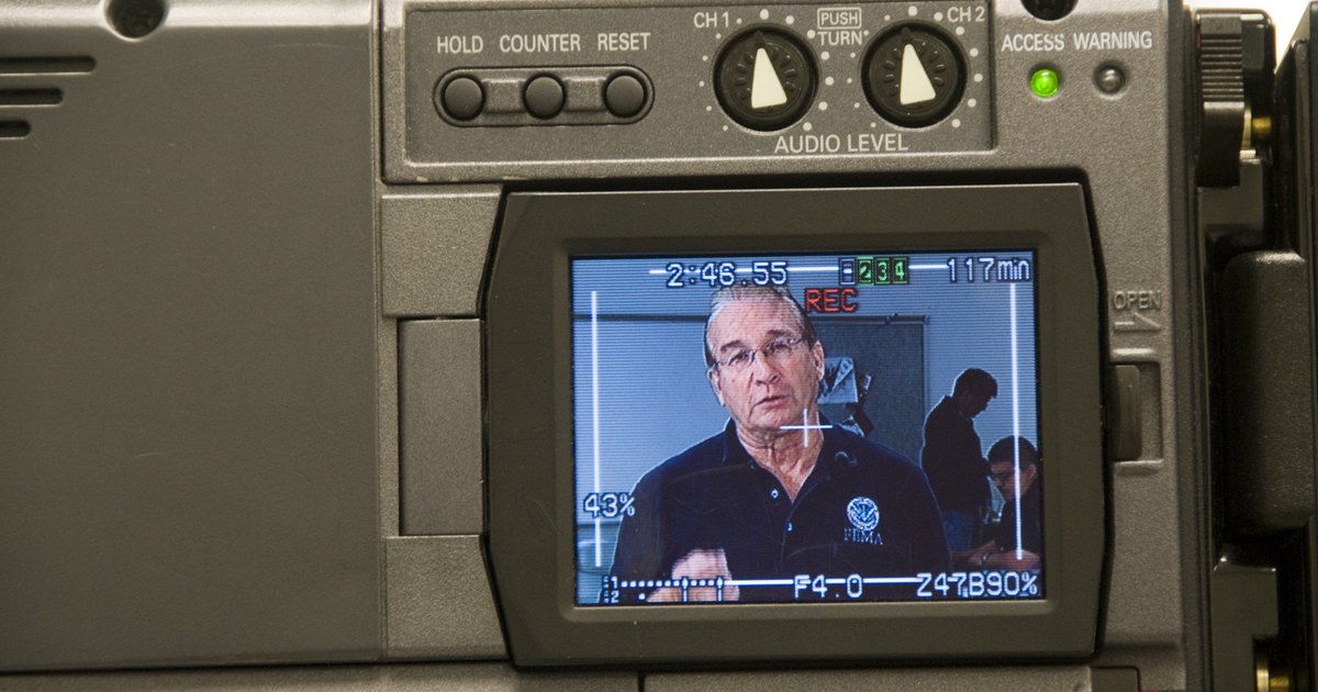 A video camera's monitor framing a man being interviewed
